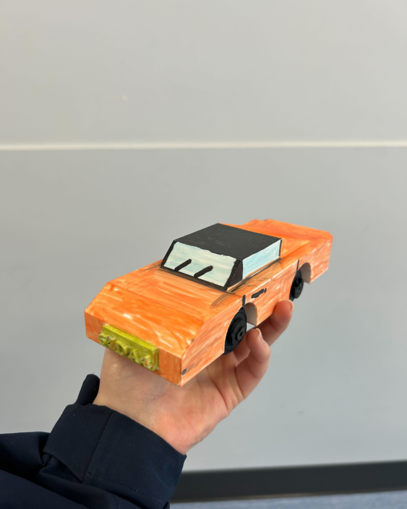 A kid working on a projectA 3D printing car from our 3Dprograms for kids (3)