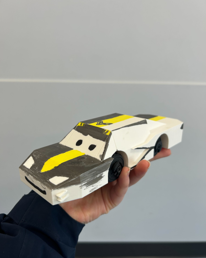 A kid working on a projectA 3D printing car from our 3Dprograms for kids (4)